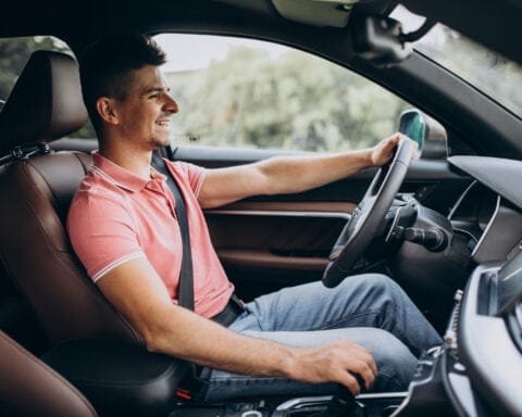 Handsome man driving in his car